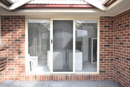 Flyscreen in front of the middle panel of a sliding door
