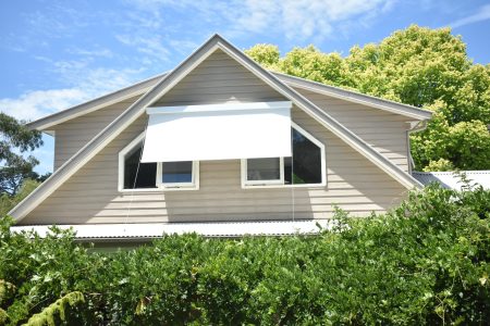 Awnings over the second-floor windows of a house