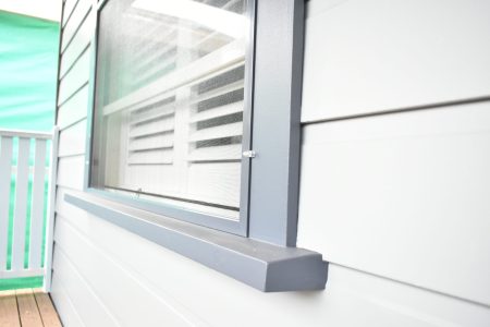 Flyscreens over a window with shutters