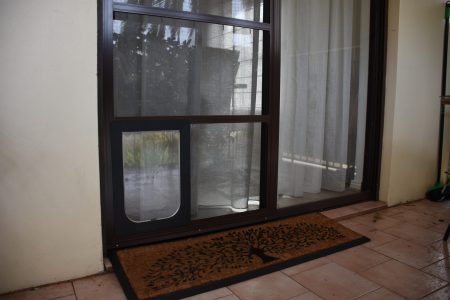 Flyscreens on a small sliding door with a pet door