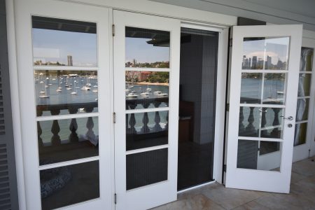 Flyscreens behind a balcony door