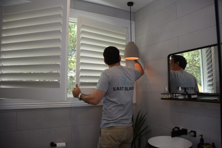 Shutters in a bathroom being installed by East Blinds
